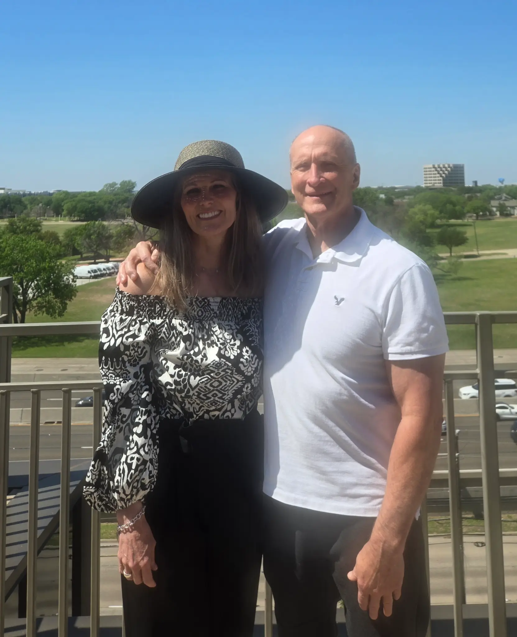Bernard and Dorothy Bourque on a balcony overlooking a green landscape